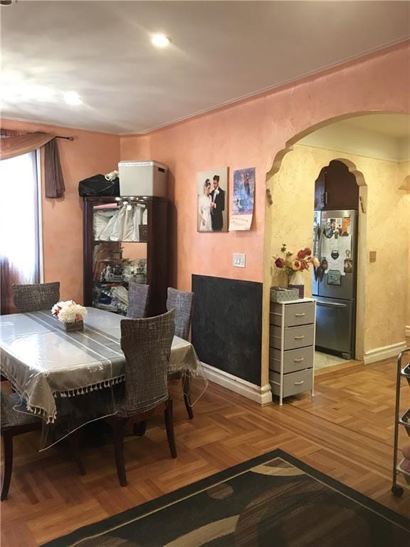 dining area with parquet flooring