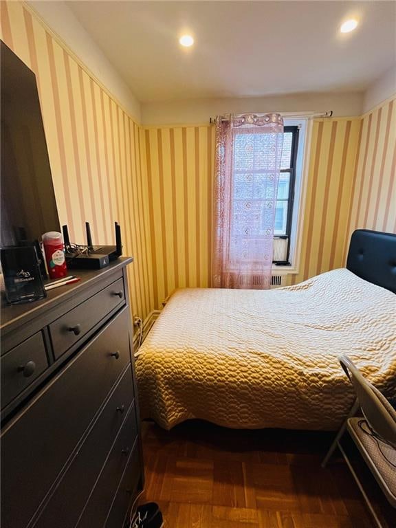 bedroom with dark parquet floors