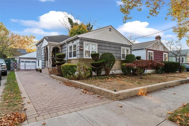 view of front of home featuring a garage and an outdoor structure