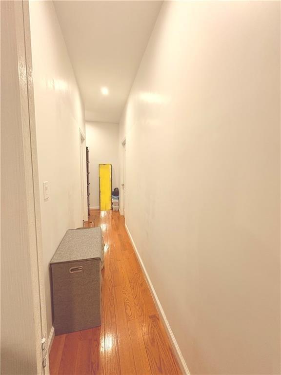 hallway with hardwood / wood-style floors