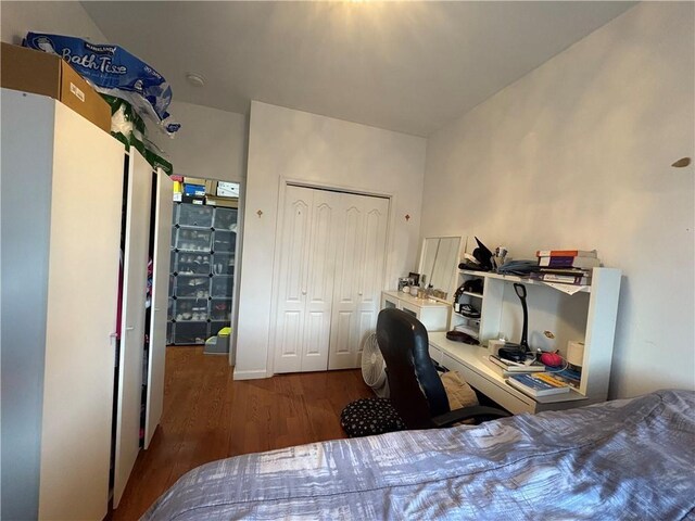 bedroom with a closet and dark wood-type flooring