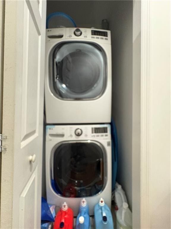 laundry room with stacked washer and clothes dryer