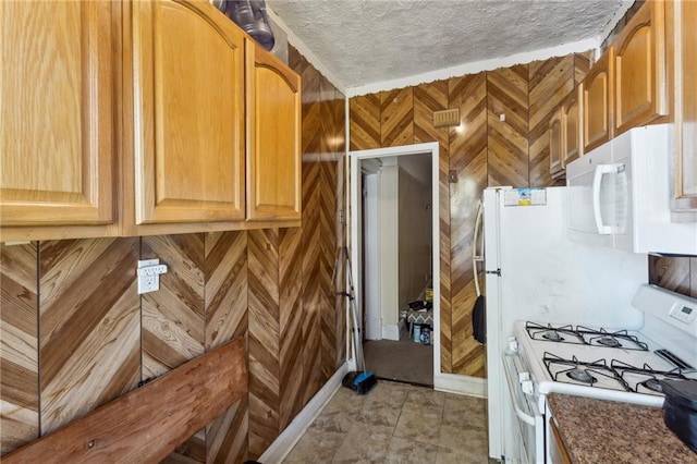 kitchen with white appliances and a textured ceiling