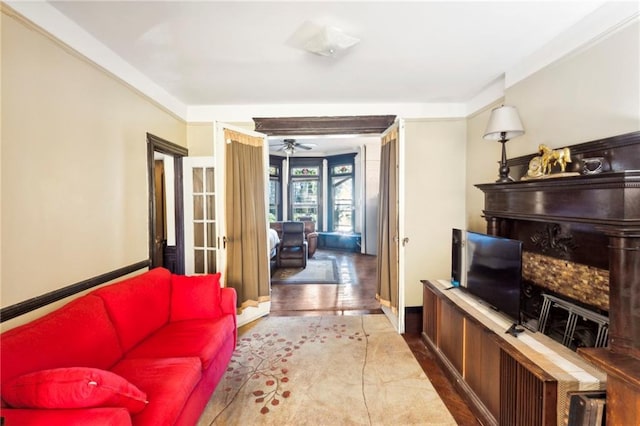 living room featuring ceiling fan, crown molding, and hardwood / wood-style flooring