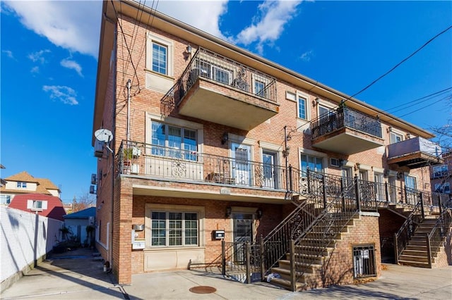 view of property with fence and stairway