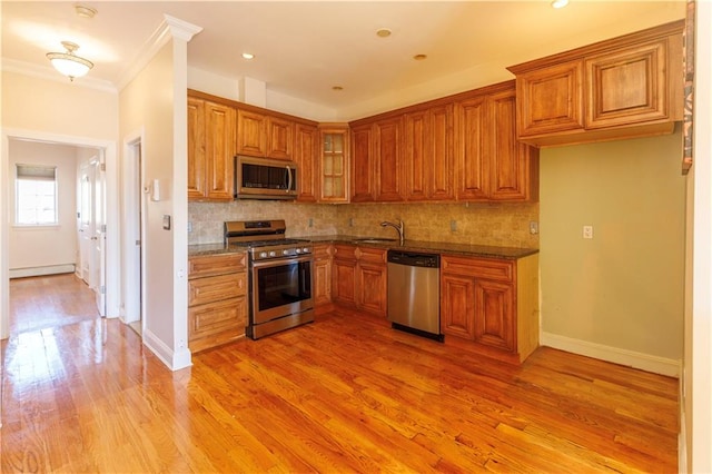 kitchen featuring a sink, brown cabinets, and stainless steel appliances