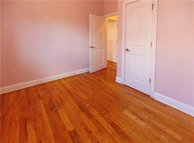 unfurnished bedroom featuring light wood-style floors and baseboards