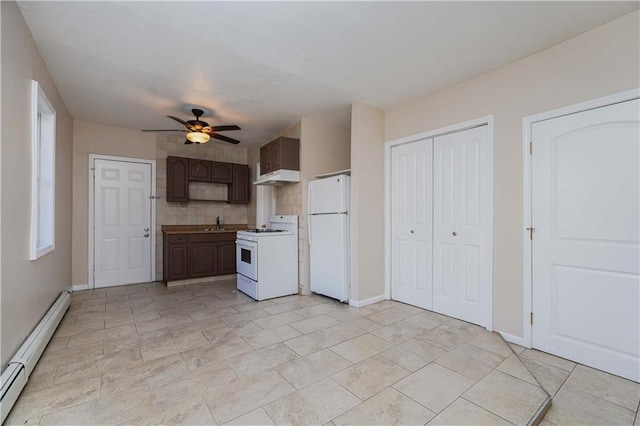 kitchen featuring dark brown cabinetry, sink, baseboard heating, ceiling fan, and white appliances