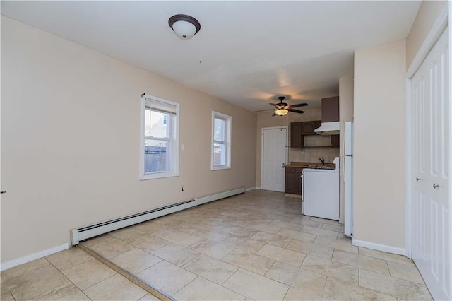 unfurnished living room with ceiling fan, a baseboard radiator, and light tile patterned floors