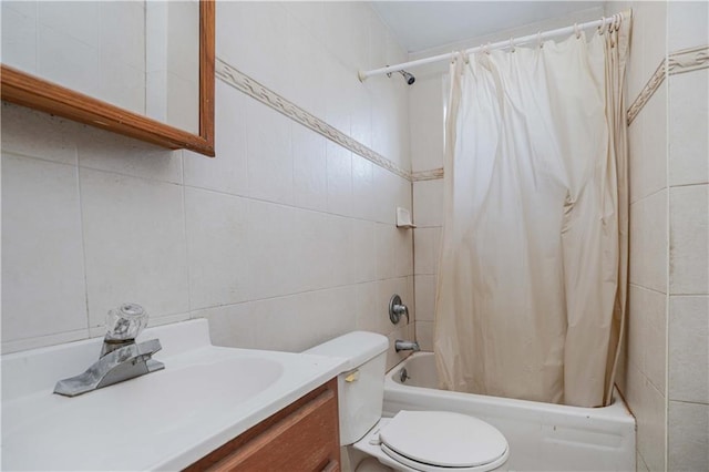 full bathroom featuring toilet, vanity, tile walls, and shower / bath combo with shower curtain