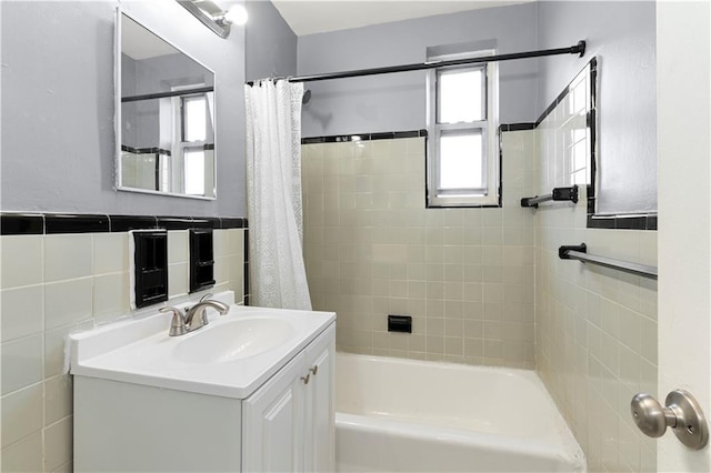 bathroom featuring shower / tub combo, vanity, and tile walls