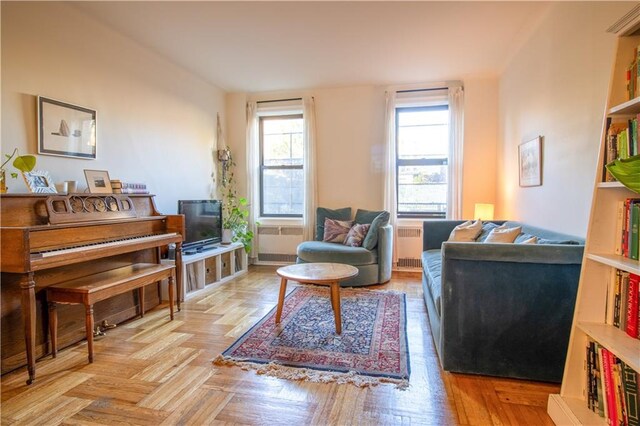 living room with light parquet flooring and radiator