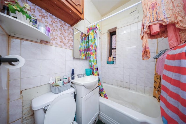 full bathroom featuring toilet, vanity, tile walls, and shower / bath combo with shower curtain