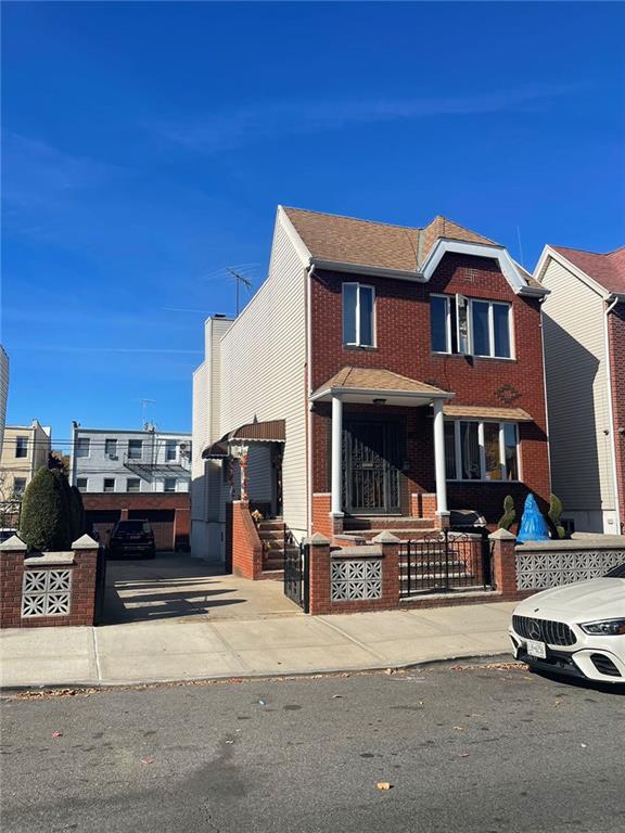 view of front facade with a fenced front yard and brick siding