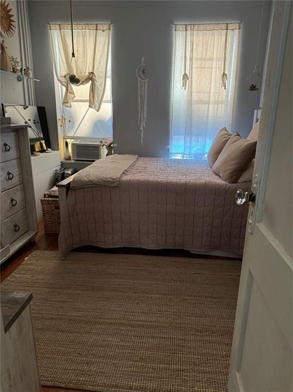 bedroom featuring dark hardwood / wood-style flooring and cooling unit