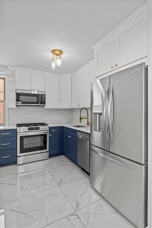 kitchen featuring sink, appliances with stainless steel finishes, tasteful backsplash, white cabinets, and blue cabinets