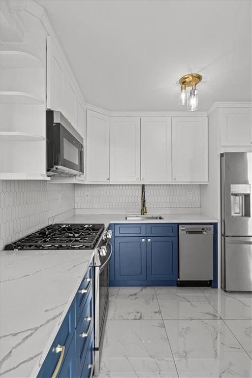 kitchen featuring sink, stainless steel appliances, light stone countertops, white cabinets, and blue cabinets