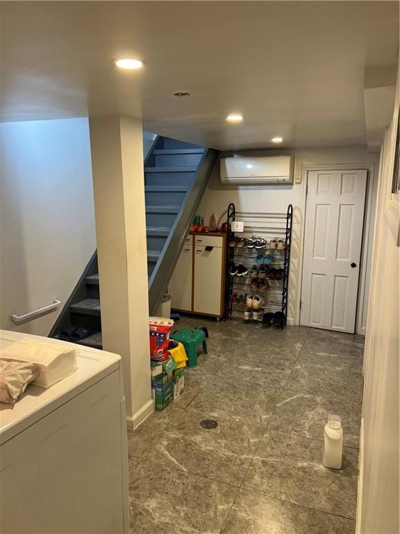 interior space featuring an AC wall unit and washer / dryer