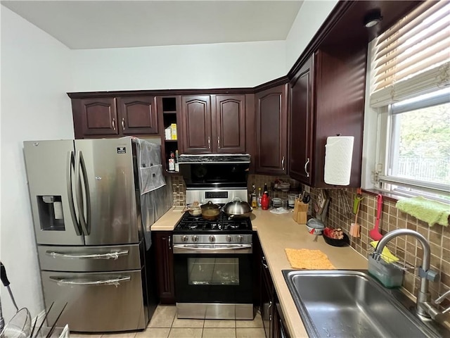 kitchen with sink, light tile patterned floors, and stainless steel appliances