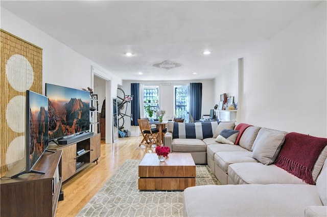 living area featuring light wood-type flooring and recessed lighting