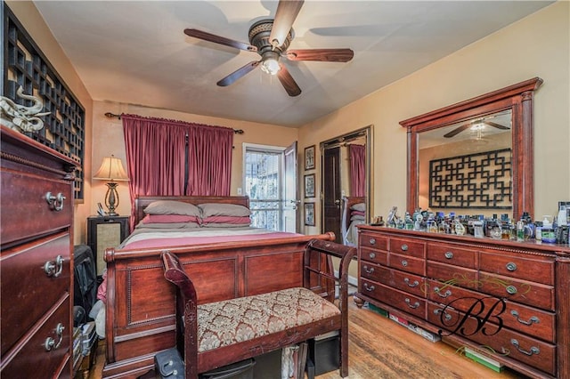 bedroom with hardwood / wood-style flooring and ceiling fan