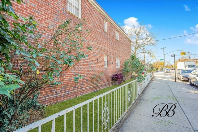 view of property exterior with a lawn