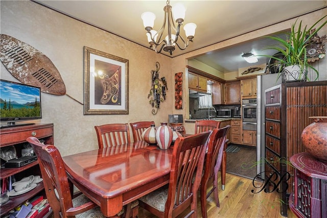 dining room with an inviting chandelier and light hardwood / wood-style floors