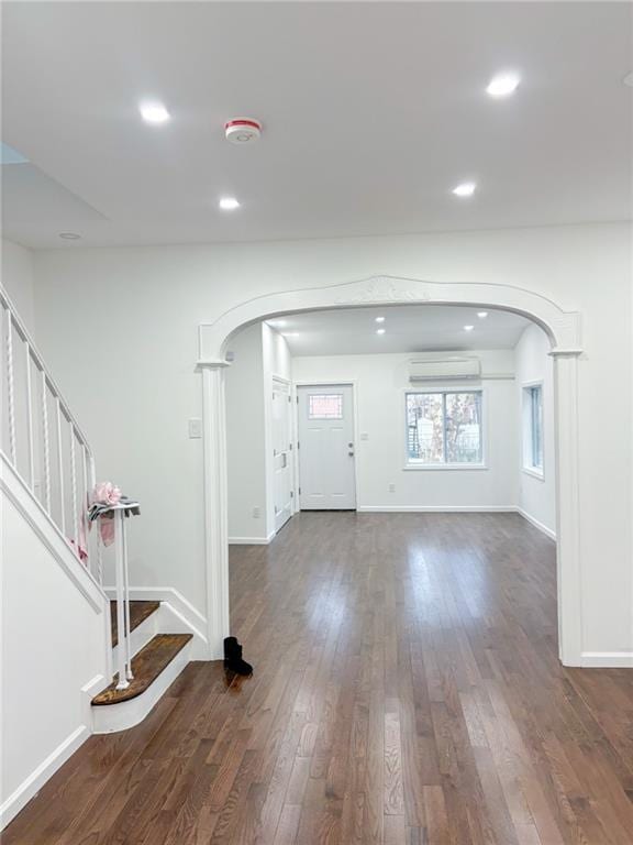 entryway featuring dark hardwood / wood-style floors and an AC wall unit