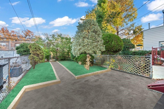 surrounding community with a yard and a patio area