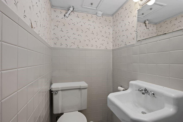 283 Bay 14th St, Brooklyn, NY 11214 - bathroom with wallpapered walls, tile walls, and a wainscoted wall