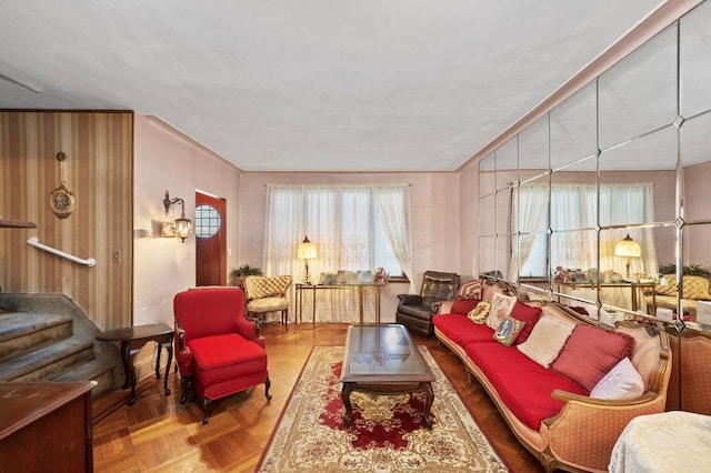 living room featuring crown molding and parquet flooring