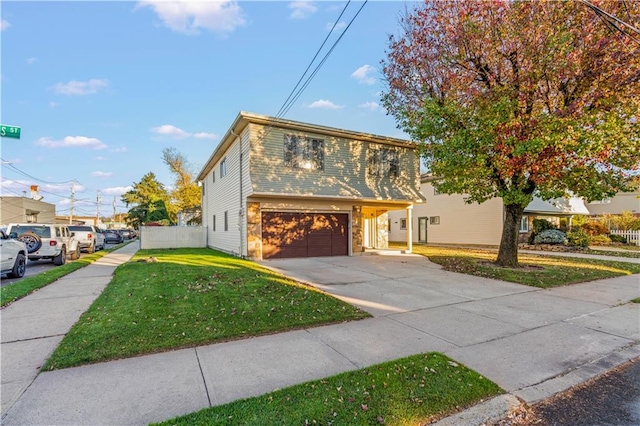 view of front of home featuring a front lawn and a garage