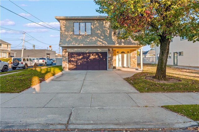 front facade featuring a front yard and a garage