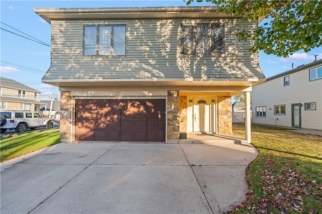 view of front of home with a garage and a front lawn