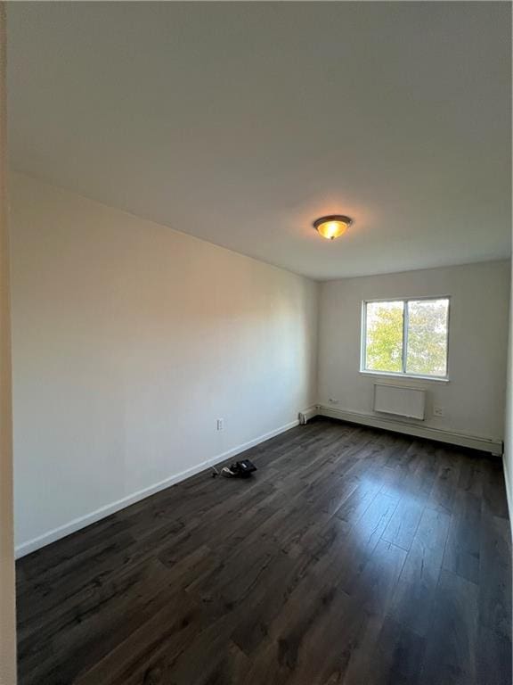 spare room featuring dark wood-type flooring