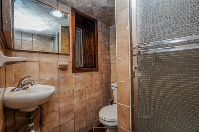 bathroom featuring tasteful backsplash, toilet, and tile walls