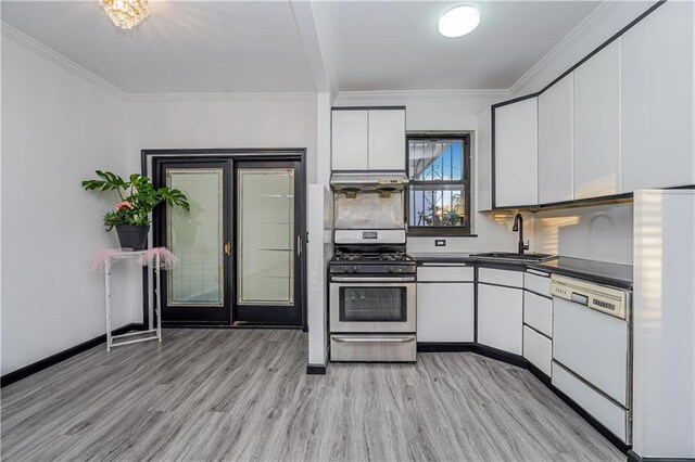 kitchen featuring white cabinets, sink, white appliances, and light hardwood / wood-style flooring