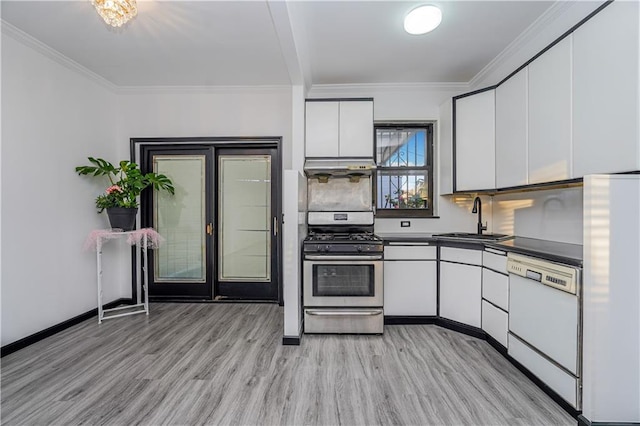 kitchen featuring white cabinetry, white appliances, dark countertops, and a sink