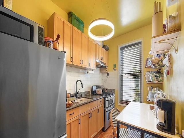 kitchen with decorative backsplash, light brown cabinets, sink, and appliances with stainless steel finishes