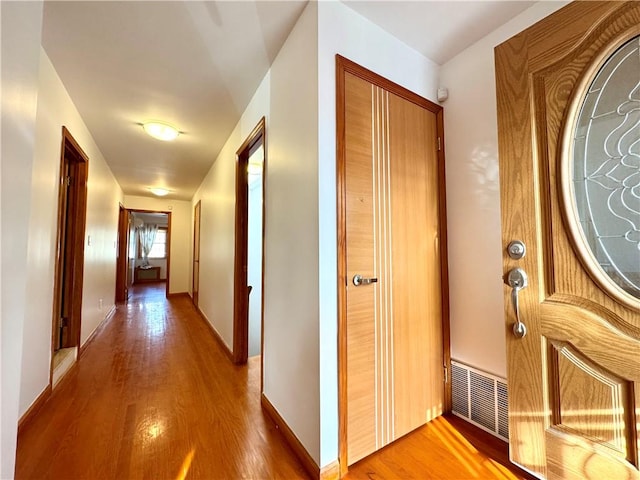 hallway with hardwood / wood-style floors