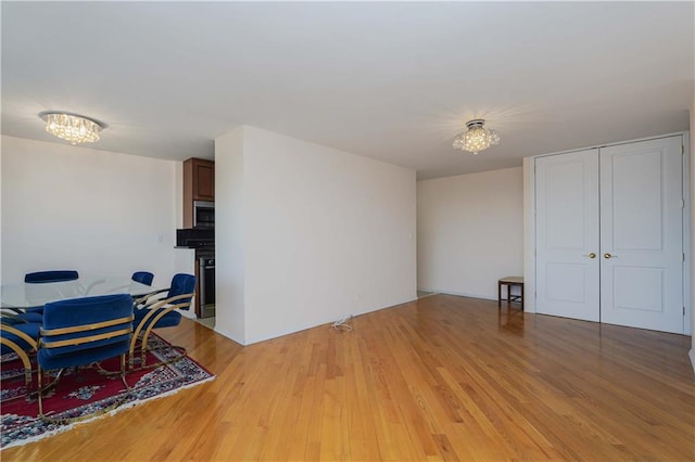 2930 W 5th St Unit 23K, Brooklyn, NY 11224 - living room featuring a chandelier and light wood-style flooring
