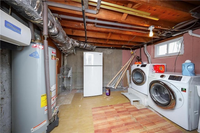 laundry area with separate washer and dryer, gas water heater, and hardwood / wood-style flooring