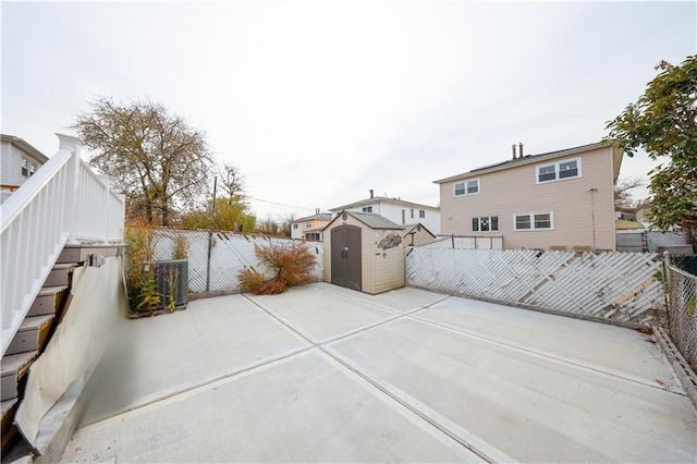 view of patio featuring a storage unit