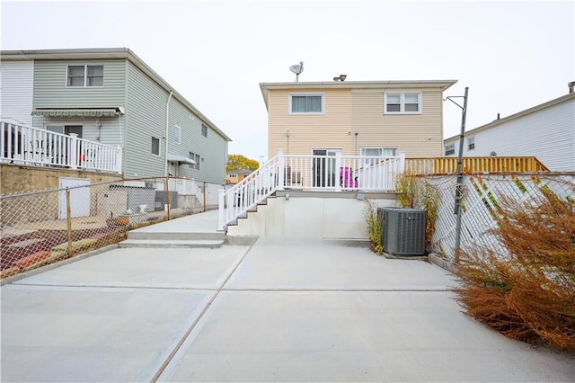 rear view of house featuring cooling unit and a patio