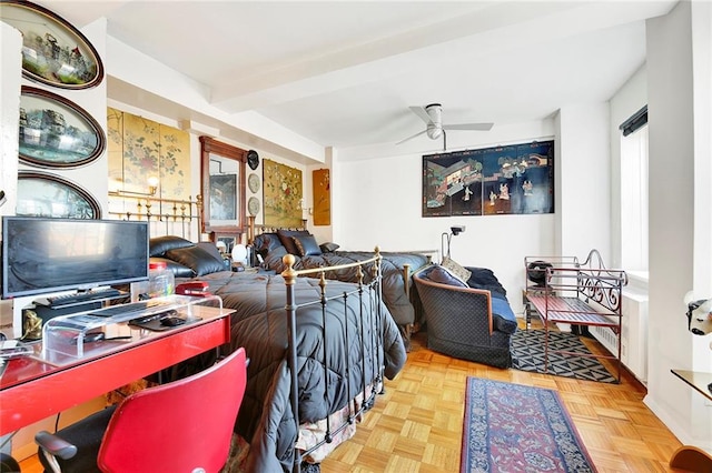 bedroom featuring ceiling fan, beamed ceiling, and light parquet floors