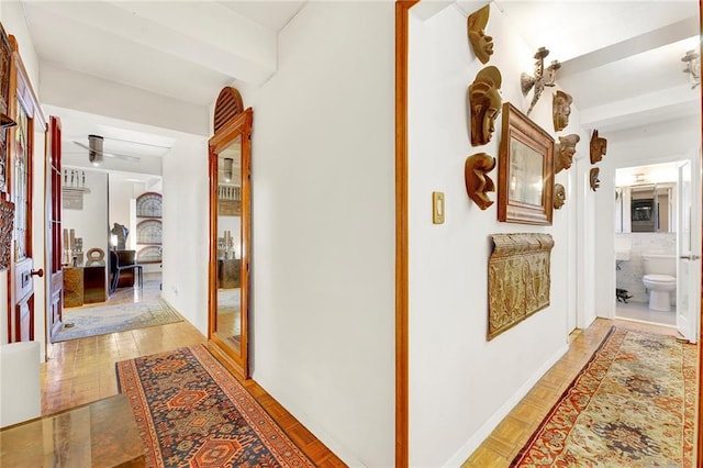 hall featuring beamed ceiling and light parquet floors