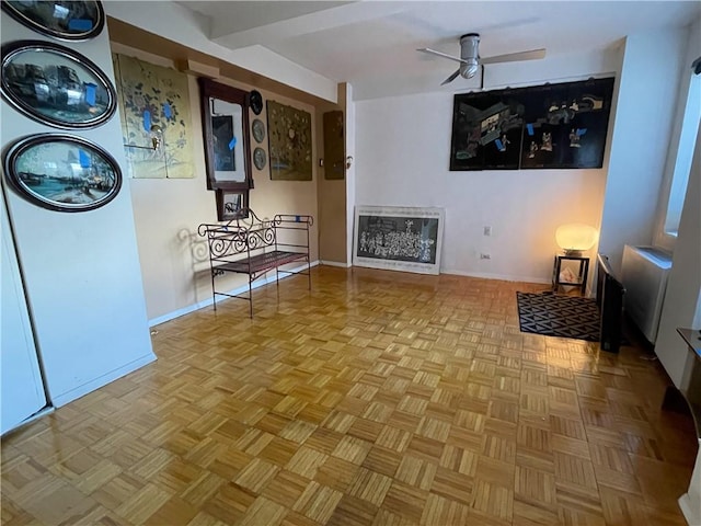 interior space with ceiling fan and baseboards