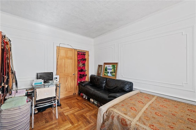 bedroom with parquet floors and a textured ceiling