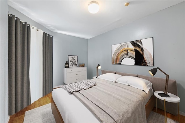 bedroom with hardwood / wood-style floors