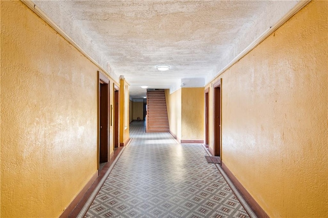 hall featuring a textured ceiling